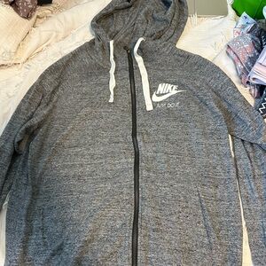 Nike brand full zip up jacket with a hood. Women’s size medium.